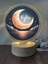 a personalized night light with a moon and the name of the child