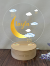 a wooden stand with a glass plate with a moon and clouds on it