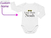 a long sleeved bodysuit with the words little dude noah printed on it