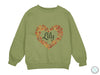 a green sweatshirt with a heart that says lily