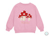 a pink sweatshirt with a red mushroom on it