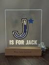 a glass block with a picture of a j is for jack