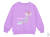 a purple sweatshirt with a rainbow and castle on it