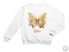 a white sweatshirt with a butterfly on it