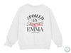 a white sweatshirt with the words spoiled by anine emma printed on it