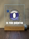 a glass block with a picture of a q on it