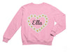 a pink sweatshirt with daisies in the shape of a heart